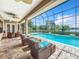 Relaxing pool and spa area with screened enclosure, offering lake views at 6245 Little Lake Sawyer Dr, Windermere, FL 34786
