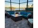 Relaxing screened patio with fire pit and lake view at 6245 Little Lake Sawyer Dr, Windermere, FL 34786