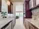Wet bar with granite countertop,wine cooler, and built-in appliances at 6245 Little Lake Sawyer Dr, Windermere, FL 34786