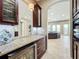 Stylish wet bar with granite countertop and wine storage at 6245 Little Lake Sawyer Dr, Windermere, FL 34786