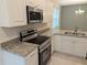 Modern kitchen featuring granite countertops and stainless steel appliances at 6929 Central Ave, Mulberry, FL 33860