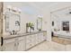 Elegant bathroom with double vanity, granite countertops, and a large mirror at 805 Hamilton Place Ct, Winter Park, FL 32789