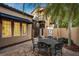 Small patio with round metal table and chairs next to spiral staircase at 805 Hamilton Place Ct, Winter Park, FL 32789