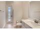 Clean bathroom features a toilet, vanity with sink, and a door leading outside at 8192 Ludington Cir, Orlando, FL 32836