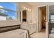 Elegant bathroom includes a soaking tub, double vanity, and a walk-in shower at 8192 Ludington Cir, Orlando, FL 32836