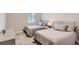 Comfortable bedroom with two twin beds, nightstands, and plenty of light at 8192 Ludington Cir, Orlando, FL 32836