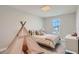 Quaint bedroom includes a full-size bed, teepee, and a dresser at 8192 Ludington Cir, Orlando, FL 32836