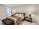 Cozy bedroom features a queen-size bed, nightstand, and access to a bathroom at 8192 Ludington Cir, Orlando, FL 32836