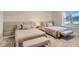 Two twin beds with upholstered headboard, light gray bedding, and a bench at 8192 Ludington Cir, Orlando, FL 32836
