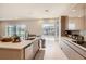Modern kitchen with island, stainless steel appliances, and access to backyard at 8192 Ludington Cir, Orlando, FL 32836