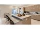 Modern kitchen with beige cabinets, quartz countertops, and island at 8192 Ludington Cir, Orlando, FL 32836