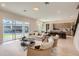Open living room with modern furniture and kitchen views at 8192 Ludington Cir, Orlando, FL 32836