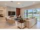 Spacious living room with modern furniture and sliding glass doors to backyard at 8192 Ludington Cir, Orlando, FL 32836