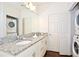 Bathroom with granite countertop, double vanity, and laundry at 8953 Shine Dr, Kissimmee, FL 34747