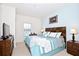 Spacious bedroom with king-size bed and TV at 8953 Shine Dr, Kissimmee, FL 34747