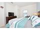 Spacious bedroom with a king-size bed, dresser, and TV at 8953 Shine Dr, Kissimmee, FL 34747