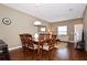 Elegant dining area with wood table and chairs, adjacent to living room at 8953 Shine Dr, Kissimmee, FL 34747