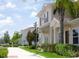 Tan two-story home with brown shutters and landscaping at 8953 Shine Dr, Kissimmee, FL 34747