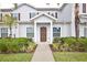 Two-story home with brown door and landscaping at 8953 Shine Dr, Kissimmee, FL 34747