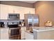 Modern kitchen with stainless steel appliances and granite countertops at 8953 Shine Dr, Kissimmee, FL 34747