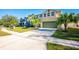 Two-story house with green garage door and palm trees at 1164 Liberty Hall Dr, Kissimmee, FL 34746