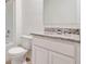 Bathroom boasts granite countertop, white cabinets, and a shower/tub combo at 1233 Limbali St, Mount Dora, FL 32757