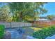 Landscaped backyard with a wooden fence and lake view at 1250 Woodridge Ct, Altamonte Springs, FL 32714