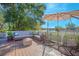 Relaxing deck with seating area and lake view, complete with an umbrella for shade at 1250 Woodridge Ct, Altamonte Springs, FL 32714
