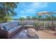 Relaxing deck overlooking a lake, featuring wicker furniture and umbrella at 1250 Woodridge Ct, Altamonte Springs, FL 32714