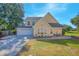 Two-story house with a large driveway, attached garage, and landscaped yard at 1250 Woodridge Ct, Altamonte Springs, FL 32714