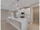 Modern kitchen with large island and white cabinetry at 1262 Venice Ct, Deland, FL 32724