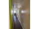 Long hallway with light brown walls and dark flooring at 1417 Highland Ave, Tavares, FL 32778