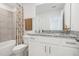 Secondary bathroom with granite countertop, white cabinets, and a tub shower combo at 1418 Fan Palm Dr, Davenport, FL 33897