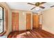 Well-lit bedroom with hardwood floors and double closet doors at 148 Ross Lake Ln, Sanford, FL 32771