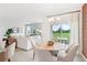 Bright dining area with wooden table and seating for four, adjacent to living room and kitchen at 1724 Blue Lagoon Cir, Mascotte, FL 34753