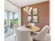 Light and airy dining area with wooden table and chairs, featuring a rustic-chic wall at 1724 Blue Lagoon Cir, Mascotte, FL 34753