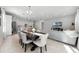 Bright dining room with dark wood table and seating for six at 1731 Reflection Ln, Saint Cloud, FL 34771