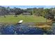 Aerial view of house, pool, and lakefront property at 2032 Dumas Dr, Deltona, FL 32738