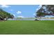 Large grassy backyard with lake views and boat at 2032 Dumas Dr, Deltona, FL 32738