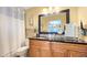 Modern bathroom with granite vanity and a large mirror at 2032 Dumas Dr, Deltona, FL 32738