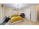 Well-lit bedroom with a queen-size bed and home gym equipment at 2032 Dumas Dr, Deltona, FL 32738