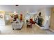 Open concept living room with a fireplace, adjacent dining area and kitchen at 2032 Dumas Dr, Deltona, FL 32738