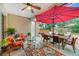 Relaxing covered patio with seating area, umbrella, and view of the backyard at 20602 Netherland St, Orlando, FL 32833