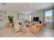 Spacious living room with light beige sectional sofa and wood coffee table at 34152 Chipping Sparrow Dr, Leesburg, FL 34788