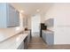 Modern kitchen with grey cabinets and vinyl flooring at 4 Cedar Trace Way, Ocala, FL 34472