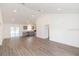 Open concept living room with grey kitchen cabinets and vinyl flooring at 4 Cedar Trace Way, Ocala, FL 34472