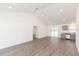 Open concept living room with grey kitchen cabinets and vinyl flooring at 4 Cedar Trace Way, Ocala, FL 34472