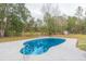 Kidney-shaped swimming pool in backyard setting at 4 Cedar Trace Way, Ocala, FL 34472