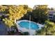 Community pool with surrounding landscaping at 4155 Versailles Dr # 4155G, Orlando, FL 32808