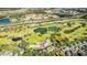 Aerial view of a golf course community with a clubhouse and surrounding residential area at 418 Water St, Kissimmee, FL 34747